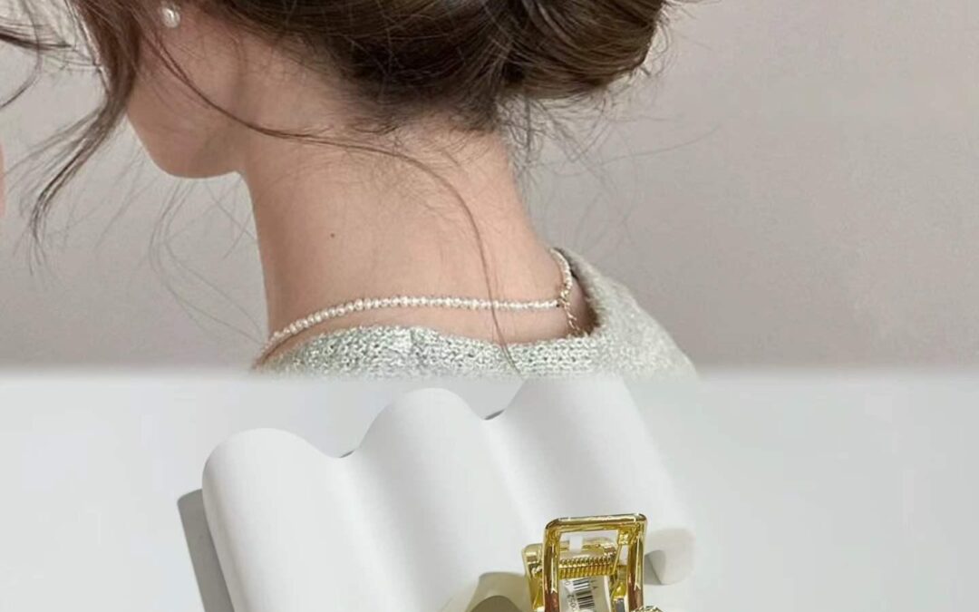 Pearl and floral claw clip holding an elegant low bun updo
